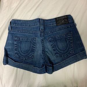 Medium/dark denim true religion shorts.